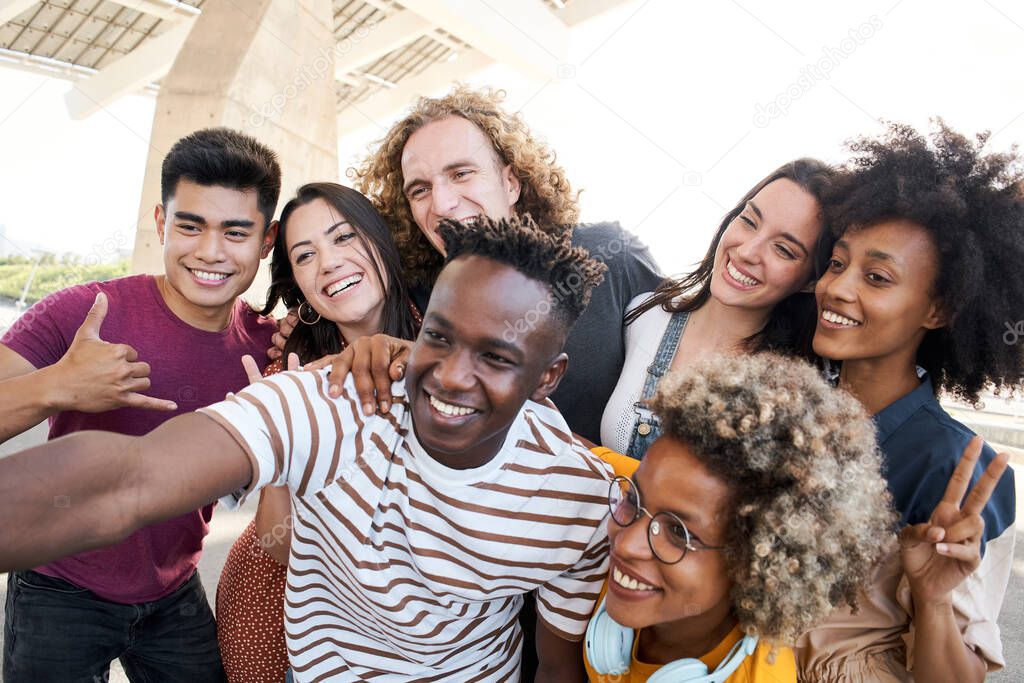 Portrait of friends take a picture with a mobile phone. Multiethnic concept, selfie, friendship.