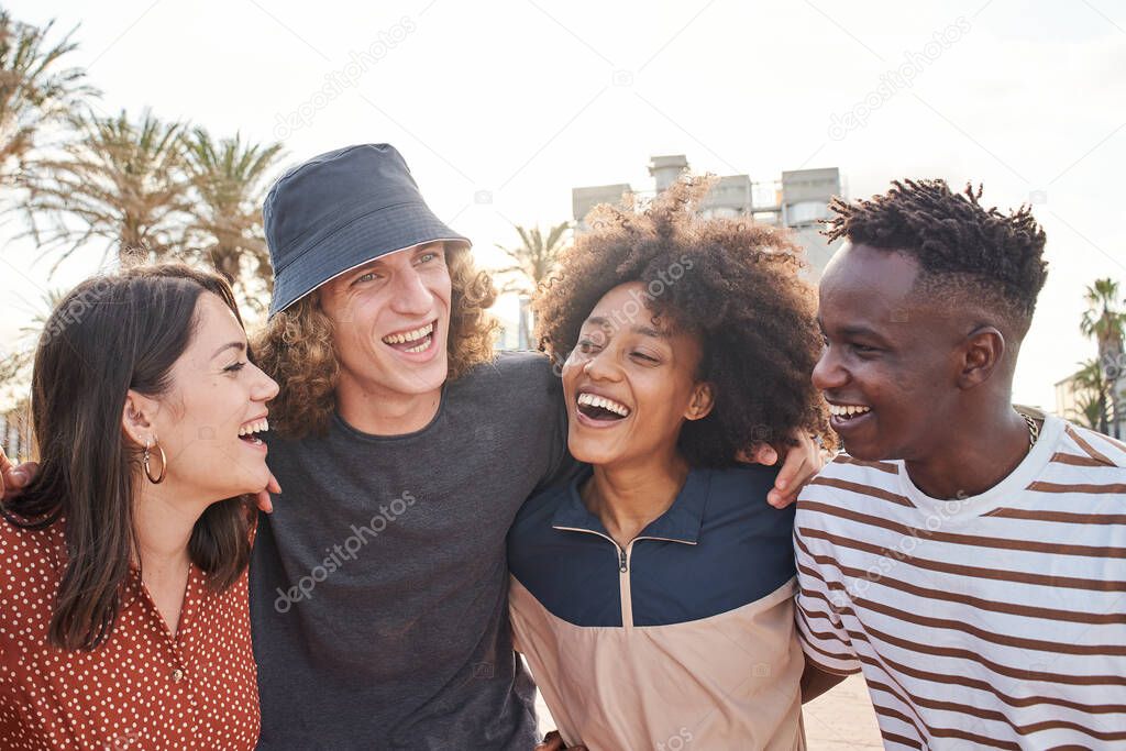 A group of young boys and girls of different nationalities enjoy hugging each other. Nice smiles of beautiful people.