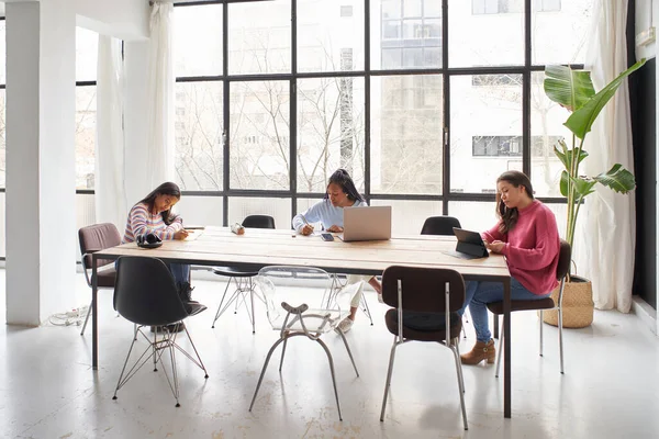 In ufficio. Tre donne d'affari lavorano insieme senza maschere pur mantenendo una distanza di sicurezza. — Foto Stock