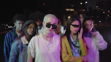 Portrait of serious gen Z people looking camera with serious face. Night club lifestyle