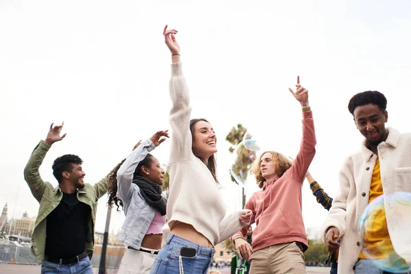 Happy people dancing outdoors. Group of friends having fun in a day party. — Stock Photo, Image