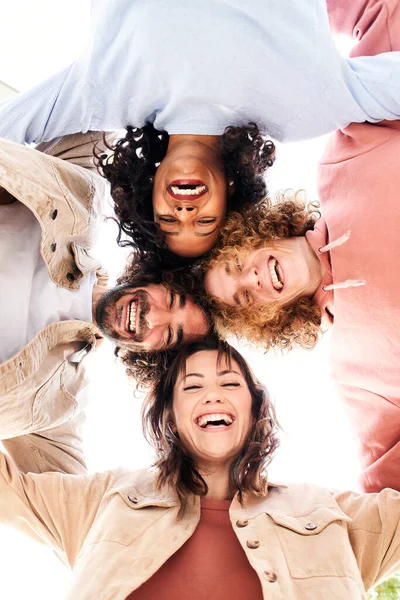 Vertical photo of a Circle of four happy young people looking at the camera embracing and having a fun. — Stock Photo, Image