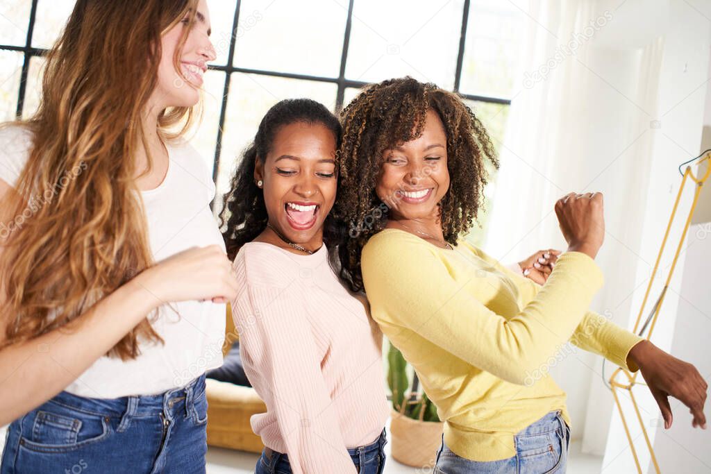 Party at home Diverse female friends dancing living room indoors. Multiracial happy women play and celebrate the joy of life Cheerful girls enjoy together having fun. 