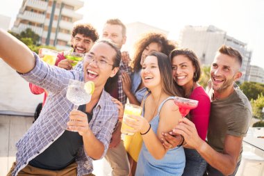 Teras barında alkol kokteyli içen insanlarla mutlu selfie. En iyi arkadaşlarımın doğum gününü kutluyorum..