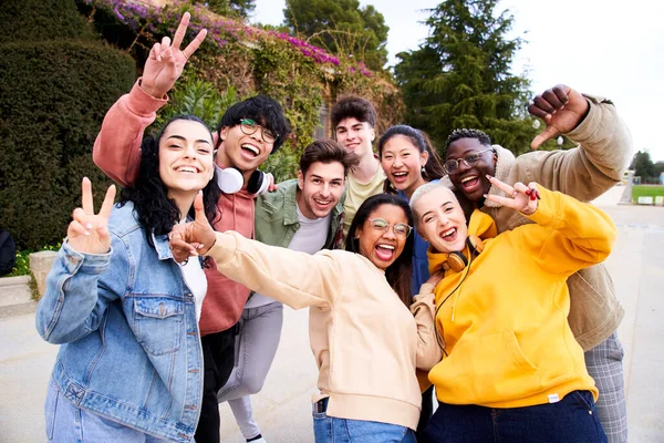 Big group of cheerful Motivated and excited young friends taking selfie portrait. Happy people looking at the camera smiling. Concept of community, youth lifestyle and friendship. High quality photo