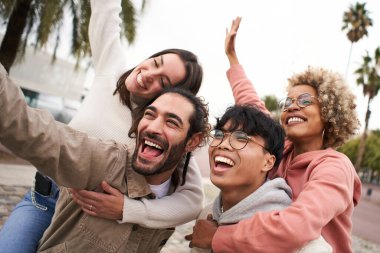 Happy young friends from diverse cultures and races taking selfie outdoors. Cheerful couples having fun together. High quality photo