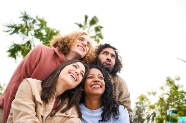 Happy young people embracing and having a fun. Smiling cheerful friends. High quality photo