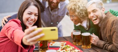 Panoramic photo of a Diverse group of friends taking a selfie at a outdoors party. High quality photo