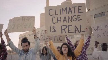Slow motion of a Group of Young People Protesting with Fist Up. Woman shouting on megaphone. High quality FullHD footage