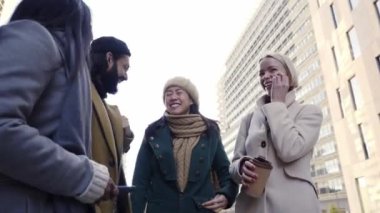 Business teamwork talking and laughing outdoors. Happy diverse people smiling together. Man and women together celebrating success at work company. High quality photo