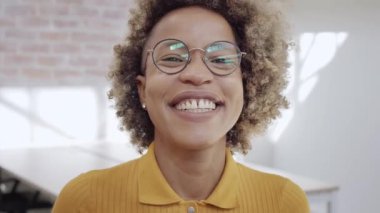Successful millennial businesswoman in suit smiling and looking at camera. Young Latin female leader office worker standing in modern office. Portraits. High quality 4k footage