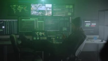 Suçlu Hacker, hükümet ve büyük şirket sunucularına büyük çaplı bir veri sızıntısı düzenlemek için bilgisayar kullanıyor. Karanlık oda bilgisayarlarla çevrili. Yüksek kalite 4k görüntü