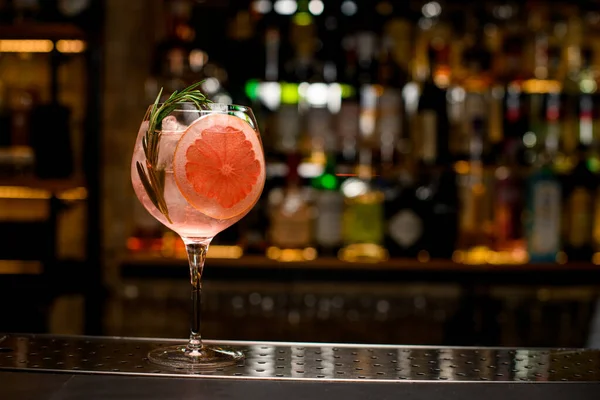 Gyönyörű serleg üveg hideg koktél díszítő egy szelet grapefruit és rozmaring ág — Stock Fotó