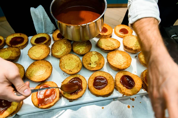 View of hamburger bun halves which hand of chef anointed with ketchup and mustard — Zdjęcie stockowe