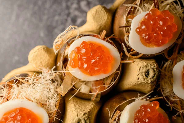 Eggs stuffed with red caviar serving in golden shell — Stock Fotó