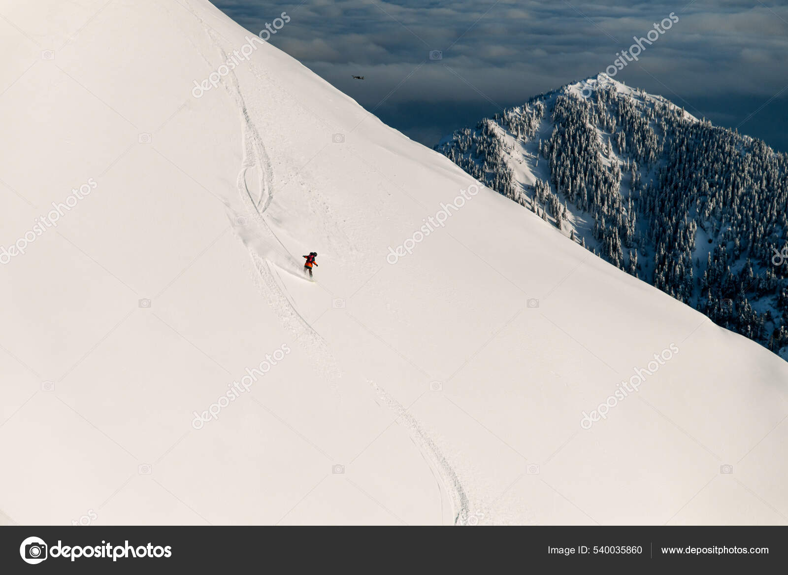 Wonderful view of mountain slope and skier sliding down on it. Freeride  skiing concept Stock Photo by ©Fesenko 540035860