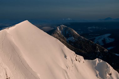 Karla kaplı dağ yamacının üzerinde insan olan harika hava manzarası..