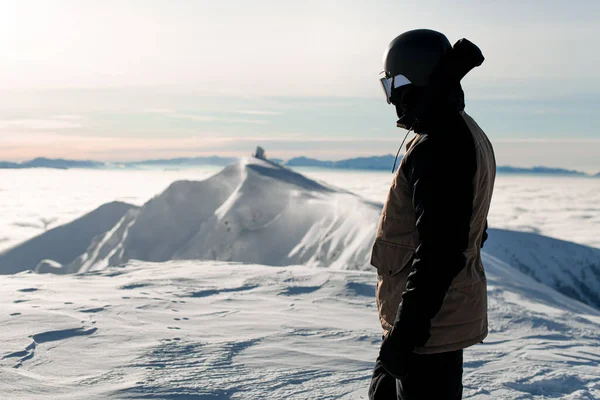 Side view of skier in ski suit and helmet against background of mountain landscape. — Zdjęcie stockowe