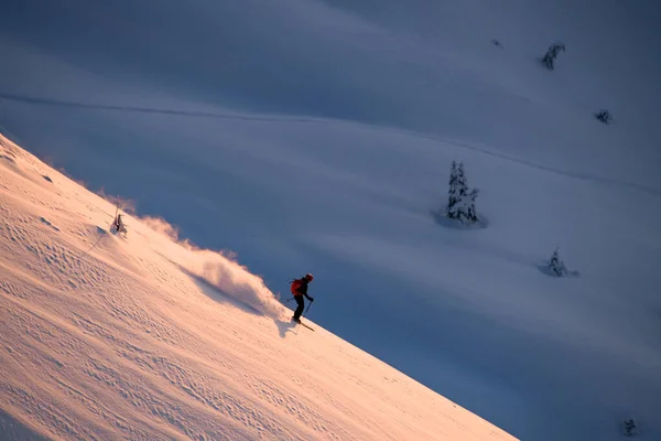 Awesome view of active male skier sliding down on mountain slope — Fotografia de Stock