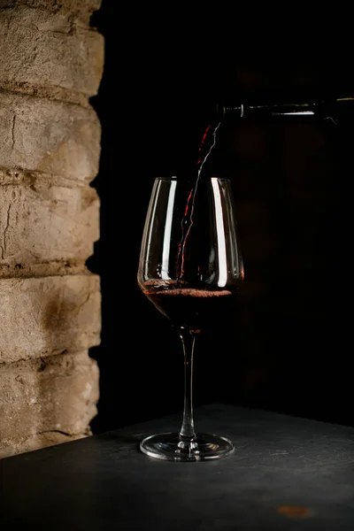 wine glass into which red wine is poured from a bottle.