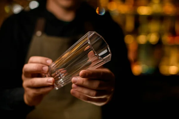 Selektiver Fokus des leeren hohen Glases zum Trinken in den Händen des männlichen Barkeepers — Stockfoto