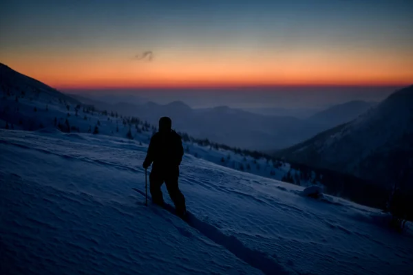 Skier with hiking equipment walking at deep snow on mountain slope. — Stock Photo, Image