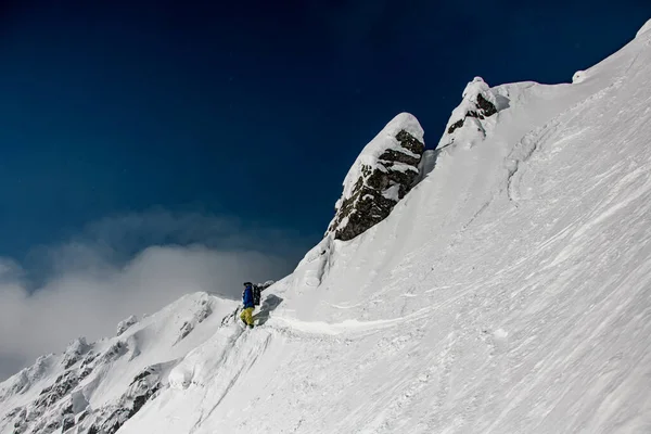 Górskie stoki pokryte białym śniegiem i męskim narciarzem na nim. — Zdjęcie stockowe