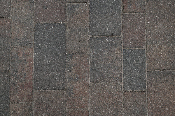 Close-up surface of grunge brown rough paving slabs. Top view. Abstract background texture. Wallpaper template. paving slabs for pedestrian street