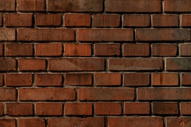 dark red brick wall texture. Abstract background texture and seamless pattern. Wallpaper of dark brown brick