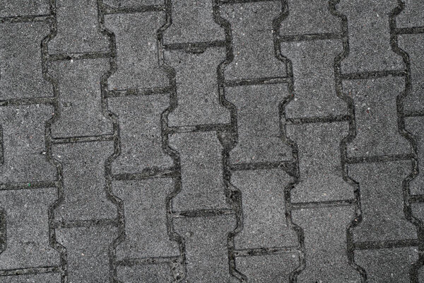 Top view on texture of grey figured paving slabs. Gray paving slabs for pedestrian street