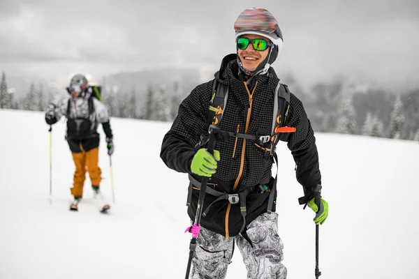 Smiling Man Skier Sunglasses Black Jacket Trekking Poles Blurred Winter — 图库照片