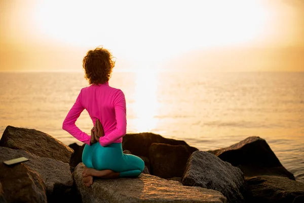 Woman Doing Yoga Namaste Her Back Sitting Stone Exercise Vajrasana — Stockfoto