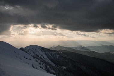 beautiful view of the sky with gray clouds and a magnificent landscape of the Carpathian mountains in winter