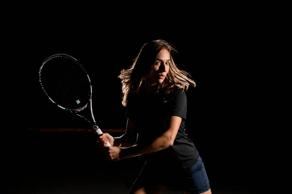 年轻女子网球选手的特写镜头 球拍随时准备击球 黑暗背景 — 图库照片
