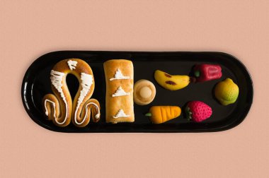 Flat lay of a tray of typical marzipan from San Dionisio in Valencia on October 9 of each year. Gift for lovers. Mocador de Sant Donis clipart