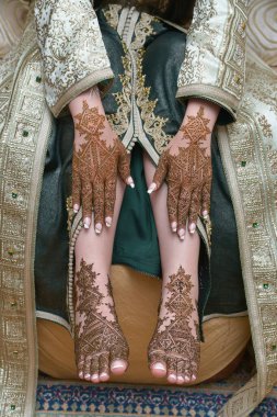 Female legs and hands with henna tattoo. moroccan bride's showing mehndi design. mehndi hands and feet. beautiful female hands with mehndi tattoos. moroccan tradition clipart