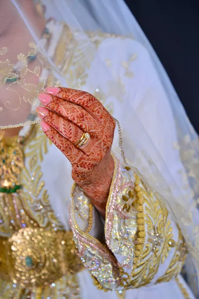 Henna Tattoo on Bride\'s Hand.Moroccan wedding preparation henna party. Temperate white mehndi. Modern mehendi art