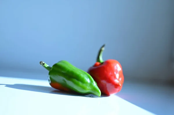 red and green bell peppers on table