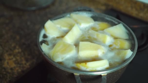 Patatas doradas cocidas en agua caliente en una cacerola. — Vídeo de stock