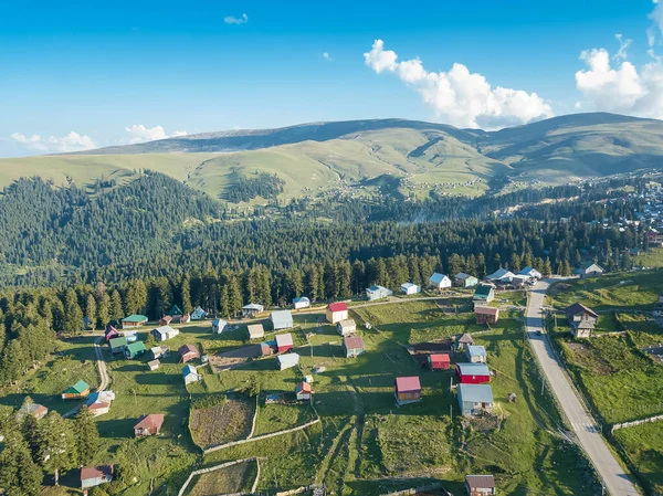 Mountain village with forests, view from a drone. Mountain landscape in Georgia, Beshumi village. Nature background, bird\'s-eye view. Shooting from a drone. Valley in the mountains with houses
