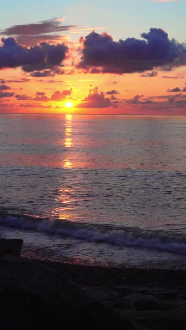 En ljus orange solnedgång i molnen på havet. — Stockvideo