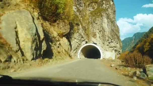 Car drives through mountain tunnel. first-person driver drives car — Stock Video
