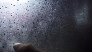 Handwritten inscription in English 911 on frosted fogged glass.