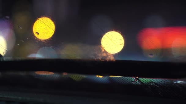 Βροχή πέφτει στο παρμπρίζ του αυτοκινήτου. Θέα από το εσωτερικό του αυτοκινήτου, — Αρχείο Βίντεο
