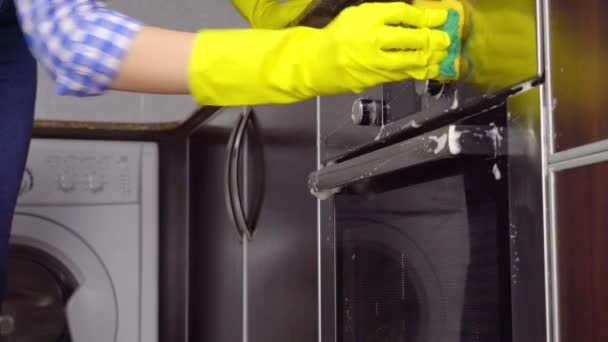 Woman hands in protective gloves cleaning oven with rag — Stock Video