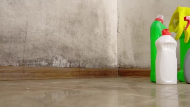 Camera movement on slider. Three bottles stand on floor with yellow gloves — Stock Video