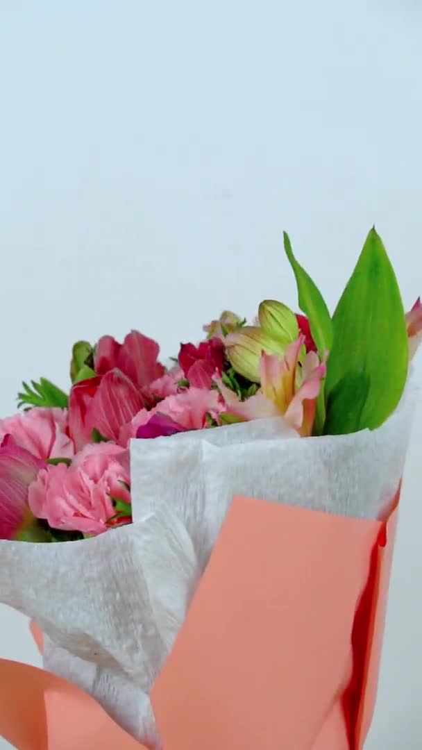 Komposisi bunga merah muda halus dalam kotak hadiah putih berputar di atas meja. — Stok Video