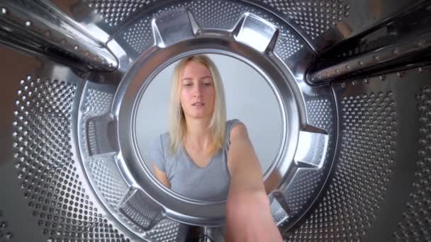 Young Beautiful Housewife Counts Dollars Money Washing Machine View Wide — стоковое видео