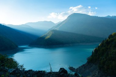 Günbatımında turkuaz su ve dağ manzaralı, Gürcistan 'daki rezervuarın güzel atmosferik manzarası. Inguri hidroelektrik santrali yakınında güzel bir Inguri nehri.