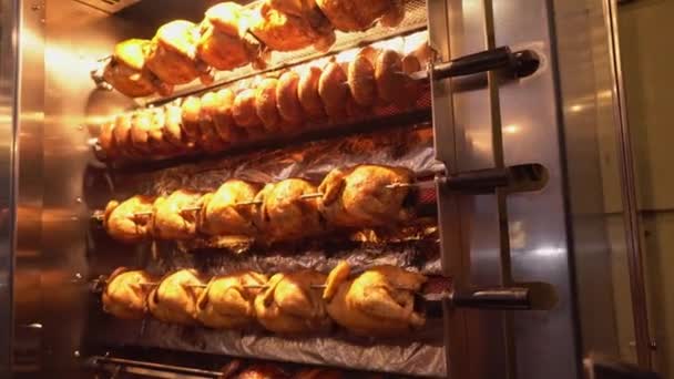 Grilled chicken is swirling on stove. Whole chicken skewers, — Stockvideo